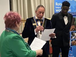 District Governor Penny Spiller and President David Dixson induct new member Baba Ibrahim
