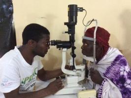 Ophthalmic surgeon examines a patient.