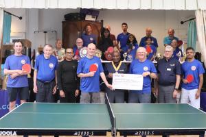 Vice President Collin Griffith with Youth Services Chair Paul Vaesen handing over the grant cheque to Bishopstone Table Tennis Club Chair David Holmes and other members of Bishopstone Table Tennis Club
