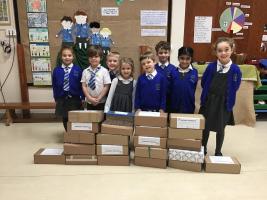 Little Apples Pre-School with the shoeboxes they collected.
[Photo reproduced with kind permission of the School Bursar]