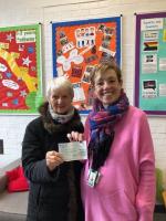 Rotarian Maggie Saunders presents cheque to Melton Young Carers