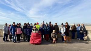 Rotarians, partners and friends assembled by the Martello Tower before the start of the walk