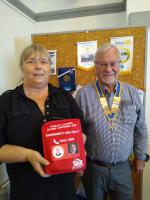 Julie is pictured holding an Emergency Bleed Control Kit, alongside Barry Clark the Club President