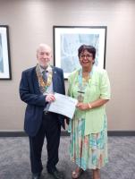 President Phil Barham presenting a cheque from the club to DG Jaz Dhaliwal for her chosen charities, (Feed the Hungry UK and Dementia Care)