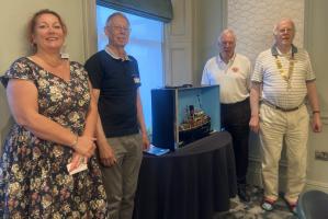 President Peter Sherred with four of our guests and a model of Tug Boat Servia