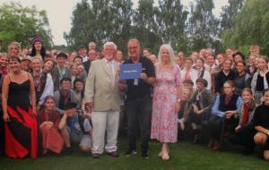 David McNeill, accompanied by Carol Graham and Tony Parrini with members of StagedRight, receiving his Paul Harris Fellowship.
