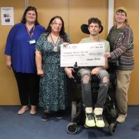 From the left:  Peer Support Worker Kimmie Oakley- Ives, President Mandy Davis presenting the donation cheque to recovery Worker Simon aided by Sky