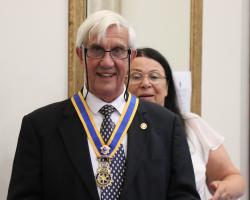 President Clive Livingstone wearing the new jewel placed on his shoulders by Immediate Past President Mandy Davis