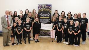 President Clive Livingstone presenting the donation to members of Rhapsody Artist Development