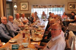 The crowed room with members recovering after the meal