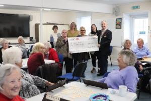 President Mike Barker presenting the grant cheque to Viv Reynolds from St James Trust supported by volunteers (from rear left) Stephanie Baker, Mary Lumley from Seafriends, Anna Tilling and Carrie– Anne Holman
