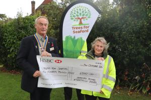 President Martin McGill presenting a cheque for £1000 to Dawn Woodgate from Seahaven Storehouse