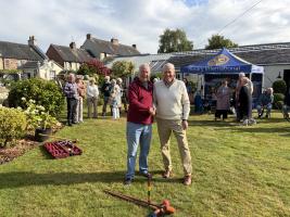 Picture of Mike Smith from EVR and Albert Jaster DR shaking hands after Mike won the croquet match 