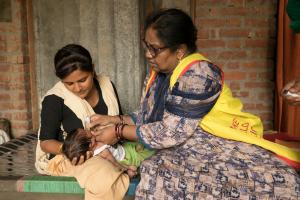 Giving Polio vaccine.