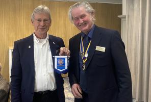 Past president Graham Dawson presents President Hugh Allen with Spaulding Rotary Club Pennant