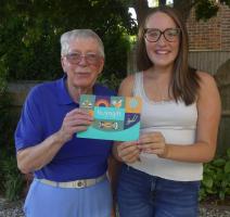 Maisie receives her gift from Rotarian Brian Cope