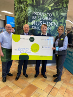 Waitrose staff present President Anton and John Garley with a cheque for £1,500