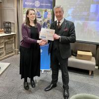 Margaret Patrizio of Edinburgh Women’s Aid receiving a cheque for £900 from Gordon Young, President of Edinburgh Rotary. 