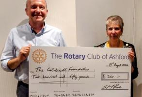 Damion Napier, Senior Manager at The Caldecott Foundation 
receives a donation from Ashford Rotary Club President-Elect,  Val Kennedy
