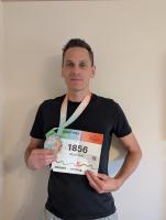 Matt poses with his medal and race number from the Munich Marathon 