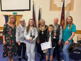 NN10s Got Talent - from left to right, Cllr Melanie Coleman, Rotarian Glenis Haynes, competition winner Millie, Mayor of Rushden Gill Mercer, competition winner Oskar, Rotary President Anton, and Ilze Lee, founder of The Never Alone Project. 