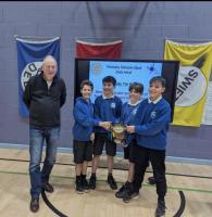 Rotarian, Stephen Dawson presenting pupils from Crossmichael primary School with the winners cup