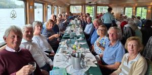 The party enjoying a meal as the boat moves down river