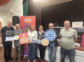 The winning quiz team with their prizes holding Rotary and End Polio Now signs.