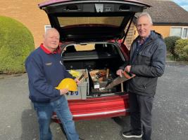 Rotarian Geoff Banks hands over crates of donated tools to TWAM volunteer Ian Reynolds