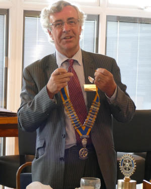 A man holding a chain of office