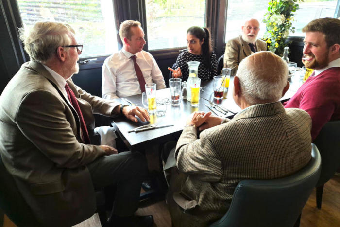 People sitting round a restaurant table by a window