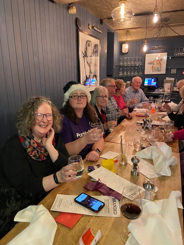 People smiling around a dinner table